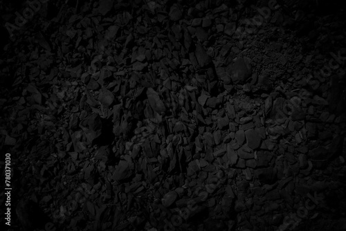 Black stone debris. Rock fragment background. photo