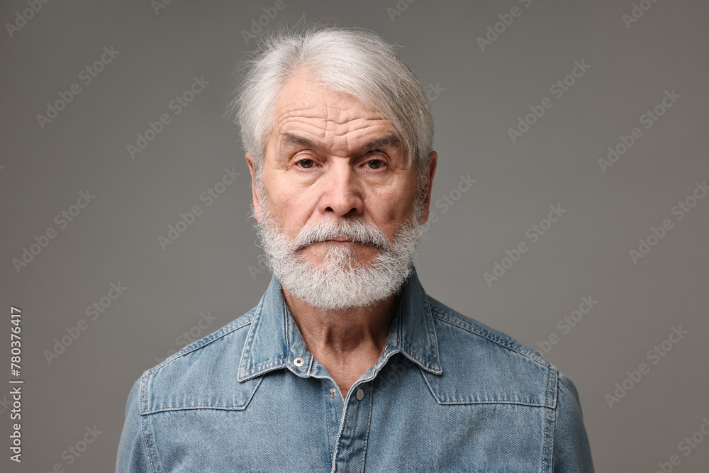 Senior man with mustache on grey background Senior man with mustache on grey background
