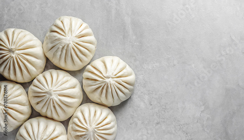 top view shot of Raw dumplings Dim Sum or chinese steamed bun on concrete table with copy space