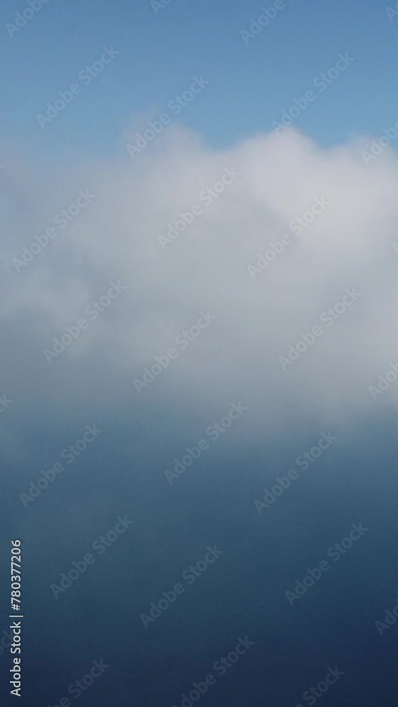 Aerial vertical view over foggy and fluffy clouds. Blue sky sun and sea fog. Abstract aerial nature summer ocean sunset sea and sky. Vacation, travel and holiday concept. Weather and climate change Aerial vertical view over foggy and fluffy clouds. Blue sky sun and sea fog. Abstract aerial nature summer ocean sunset sea and sky. Vacation, travel and holiday concept. Weather and climate change