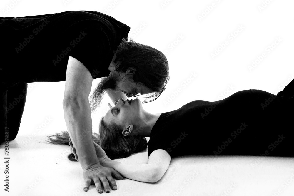 Beautiful pregnant woman and her handsome husband are kissing while spending time together isolated over white background wall. beautiful young couple expecting baby standing together and touching