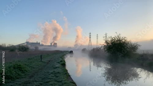 Industry and canal in winter morning with smoke coming from chimney England UK 4K photo