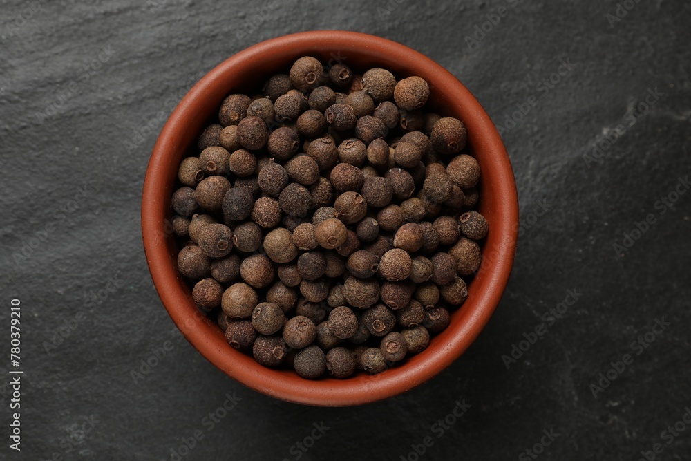 Dry allspice berries (Jamaica pepper) on black table, top view Dry allspice berries (Jamaica pepper) on black table, top view