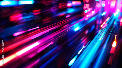 Blurred neon lights on a dark background. Abstract colorful lights, waves in motion. Night view.