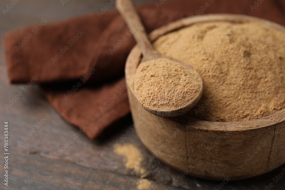 Dietary fiber. Psyllium husk powder in bowl and spoon on wooden table, closeup. Space for text Dietary fiber. Psyllium husk powder in bowl and spoon on wooden table, closeup. Space for text