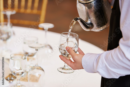 Canvas Print Waiter serving water in a restaurant