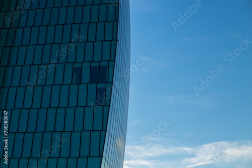 Skyscraper against the blue sky. Place for text. Glass buildings in Milan, Italy. CityLife Shopping District complex - the new commercial and residential area. Finance, economics, future concepts photo