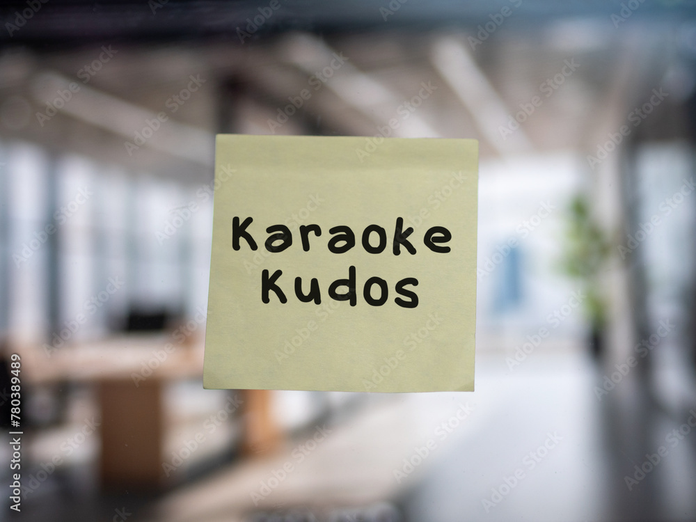 Post note on glass with 'Karaoke Kudos'.
