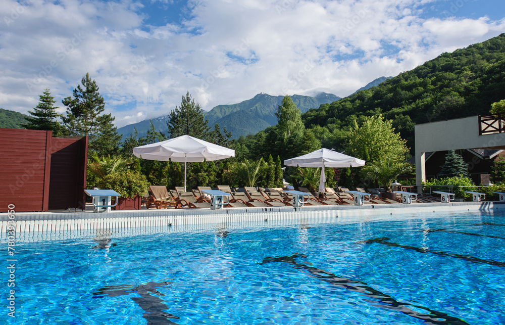 KRASNAYA POLYANA, SOCHI, RUSSIA – summer July: «Laura, GAZPROM, GRAND HOTEL POLYANA» – the warm swimming pool with view on mountains.