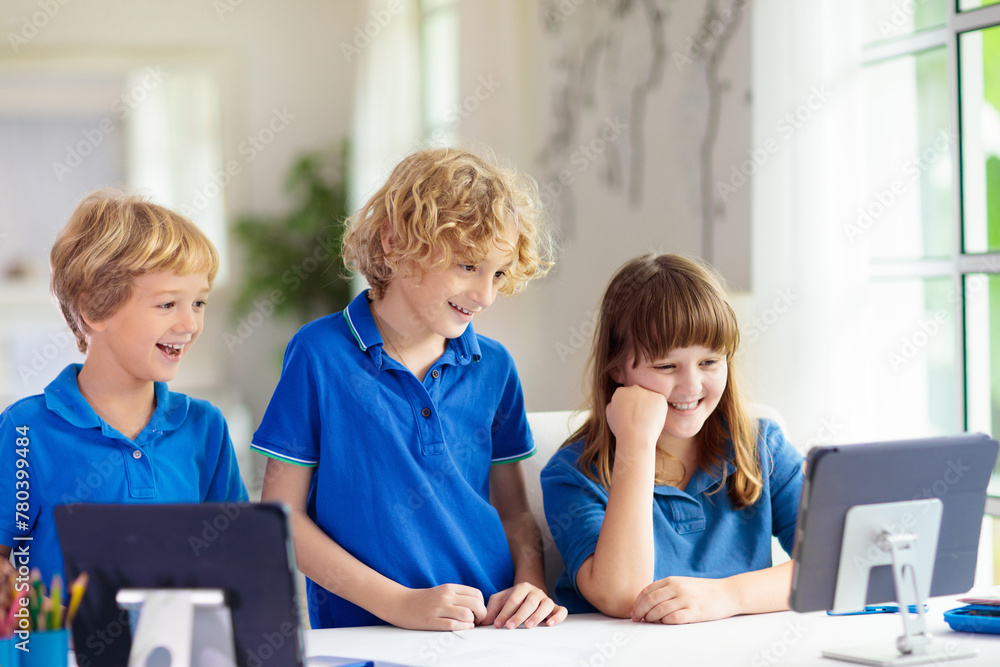 Online remote learning. School kids with computer.
