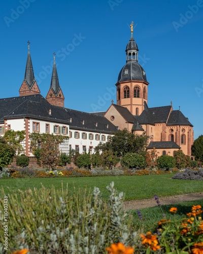 Vertical shot of the Kloster Seligenstadt monastery in Germany surrounded by a beautiful garden photo