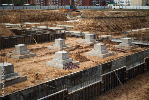 Reinforced concrete blocks are being carefully arranged and laid out on a bustling construction site