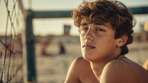 Young man sitting by a fence on the beach, AI-generated.