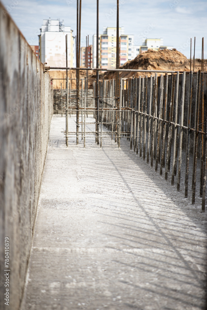 A construction site showcases a massive dirt pile, a vital element for the creation of reinforced concrete foundations A construction site showcases a massive dirt pile, a vital element for the creation of reinforced concrete foundations
