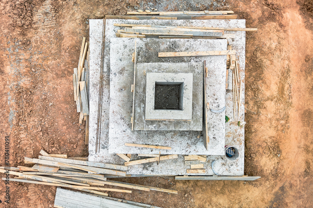 A square of wood delicately balances on a concrete slab, showcasing the contrast between natural and man-made materials in construction A square of wood delicately balances on a concrete slab, showcasing the contrast between natural and man-made materials in construction