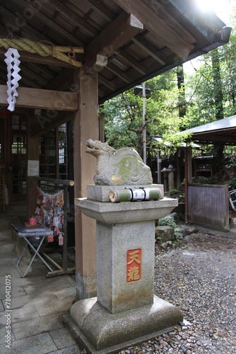 Lion statue at a shrine in the bamboo forest not far from the at Fushimi Inari Taisha shrine in Kyoto, Japan