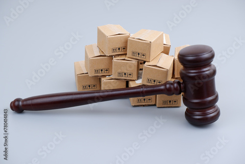 Tariffs and sanctions concept. Judge gavel and many carton boxes.	