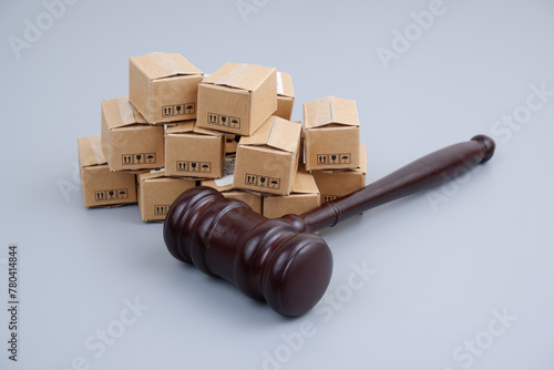 Tariffs, trade laws and taxes concept. Gavel and many carton boxes.	