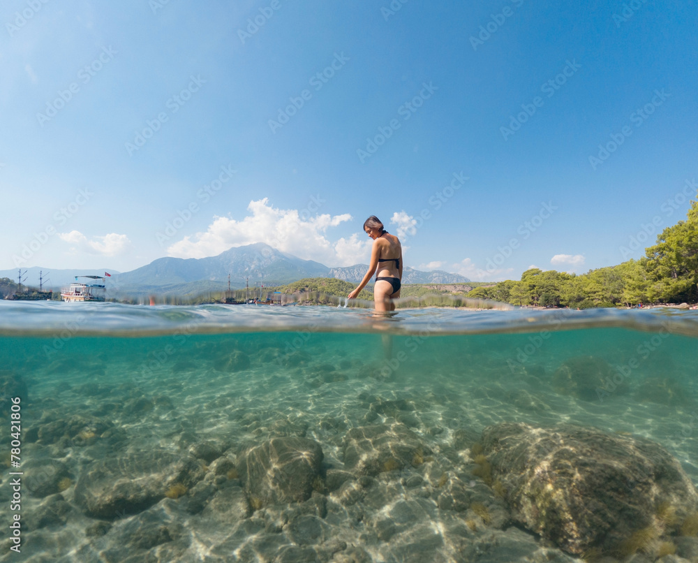 Woman on tropical vacation paradise on sea. Summer sea joy in Turkish seacoast, beaches along Lycian Way, Turkish Riviera. Asian female underwater and turquoise ocean around. Woman on tropical vacation paradise on sea. Summer sea joy in Turkish seacoast, beaches along Lycian Way, Turkish Riviera. Asian female underwater and turquoise ocean around.