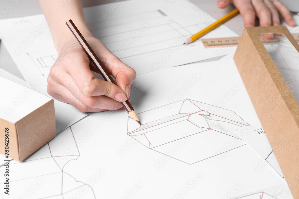 Woman creating packaging design at table, closeup Woman creating packaging design at table, closeup