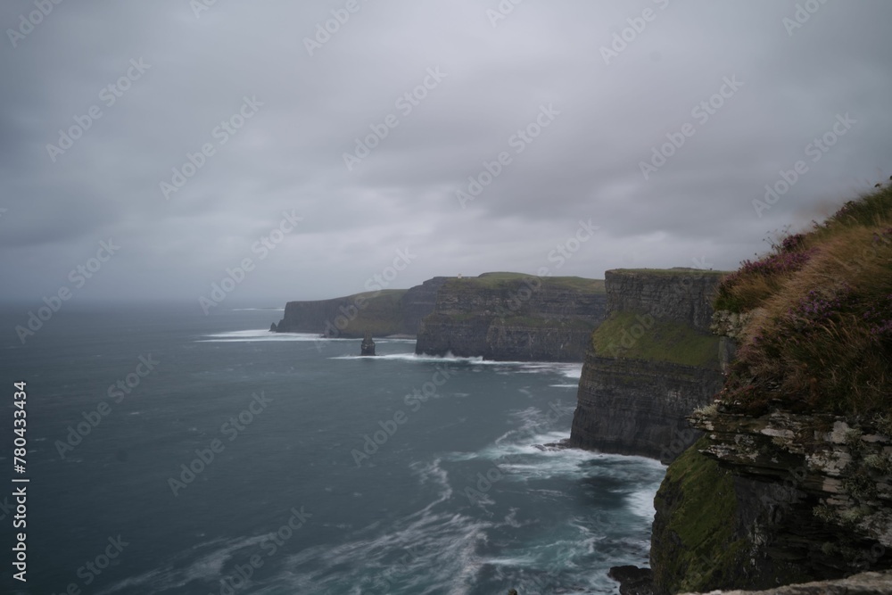 Scenic view of the evergreen Cliffs of Moher in Ireland on a gloomy day