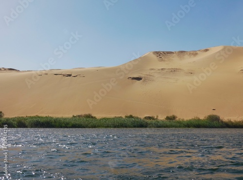 Scenic view of the Nile river and sand dunes in the background in Africa