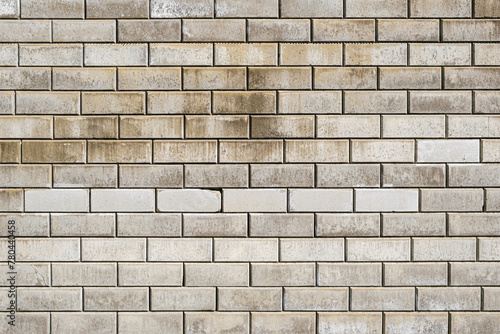 Shot of a wall of gray concrete blocks with dirt on them, background, full frame, seamless pattern, fourteen (14) rows of blocks photo
