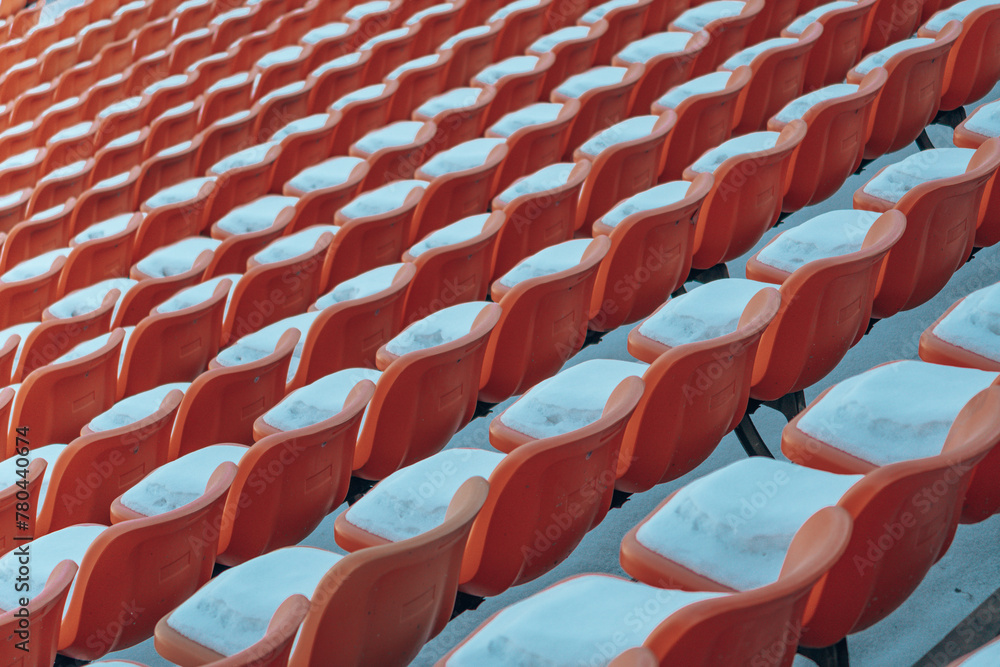 Red lines of empty red theater seats with white snow