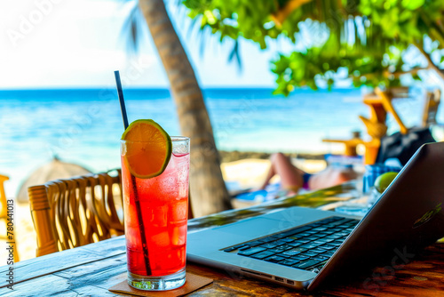 A digital nomad setup with a laptop and a refreshing drink showcasing work flexibility in an idyllic beach setting