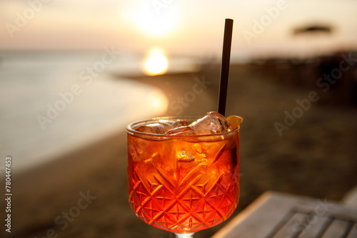 Fototapeta Naklejka Na Ścianę i Meble -  Aperol spritz cocktail in a tulip glass on a summer evening during sunset.