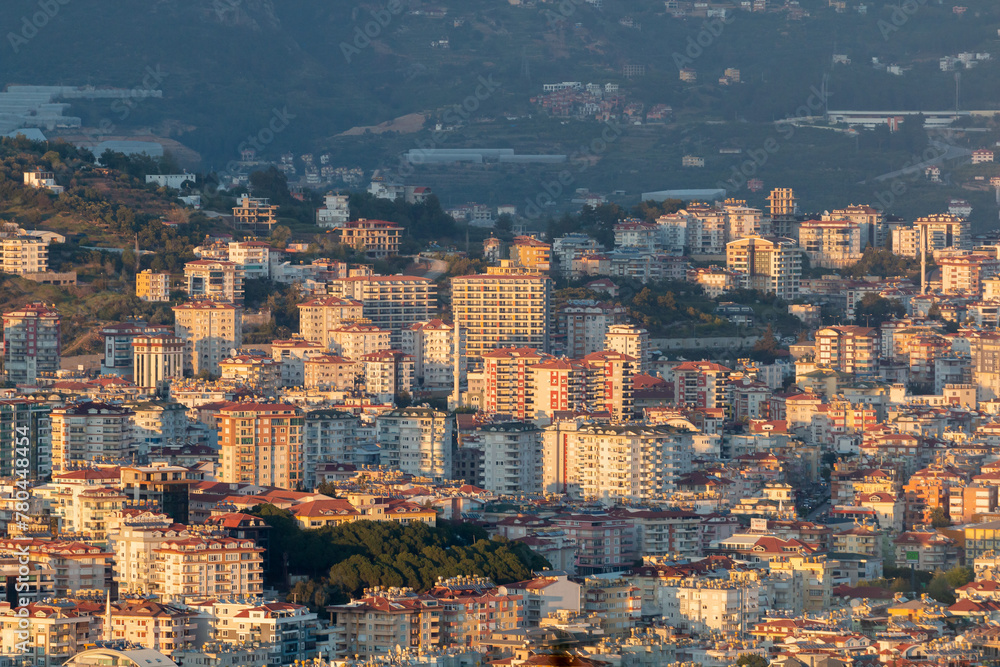 Fototapeta premium Panoramic view from Alanya Castle on city Buildings during sunset