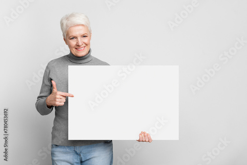 Senior woman holding a blank white board