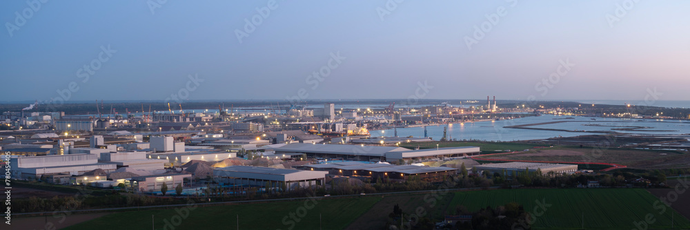 Obraz premium Aerial view of the industrial and port area of Ravenna ,chemical and petrochemical pole,thermoelectric,metallurgical plants and hydrocarbon refinery and liquefied natural gas tanks