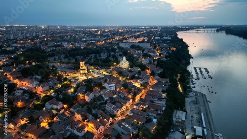 Aerial shot of the illuminated Zemun village and Belgrade next to the Sava river in the evening photo