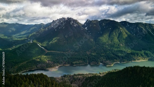 Beautiful view of the mountains and a lake under a cloudy sky in Lynn Headwaters Park in BC, Canada.