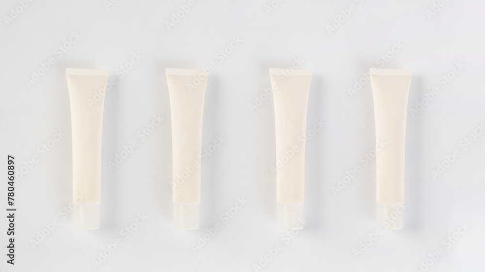 Plastic white tube for cream or lotion. Skin care or sunscreen cosmetic on white background. Plastic white tube for cream or lotion. Skin care or sunscreen cosmetic on white background.
