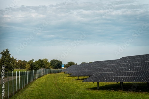 Solar system panels in the large photovoltaic power plant in the green field