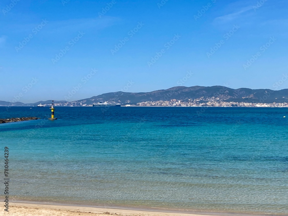 Coastal town in distance and blue sea in the Balearic Islands, Mallorca, Spain