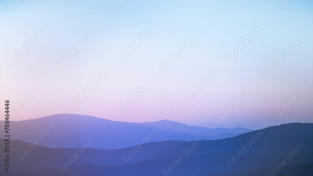 Layers of dreamy silhouette of the mountain range between sunset and blue hour