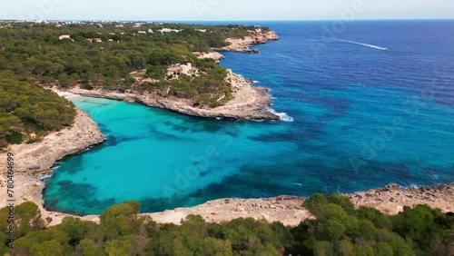 Aerial view of Cala Mondrago's turquoise waters and lush woodland in Mallorca. photo