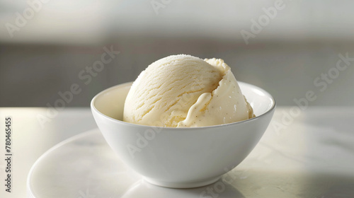 Creamy vanilla ice cream served in a white bowl on a minimalist white table, capturing the essence of simplicity and indulgence with a focus on the rich, smooth texture and classic flavor of the ice