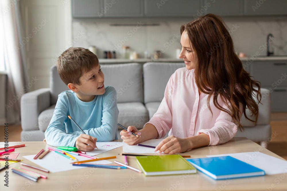 Mother and son talking and drawing together Mother and son talking and drawing together