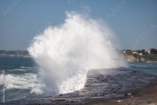 huge wave splashing against the dike