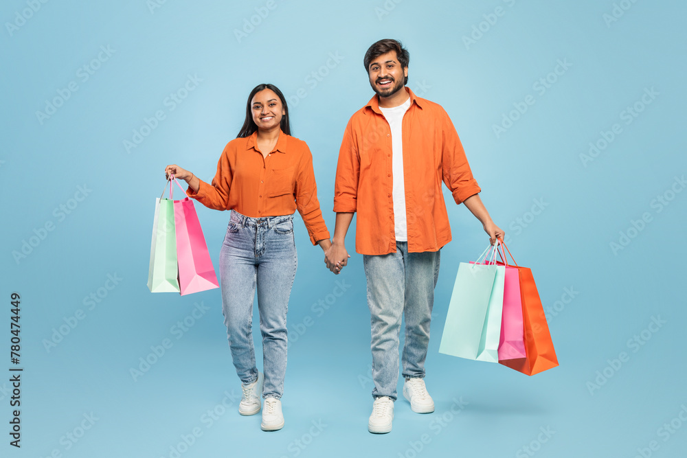 Couple walking with shopping bags looking happy Couple walking with shopping bags looking happy