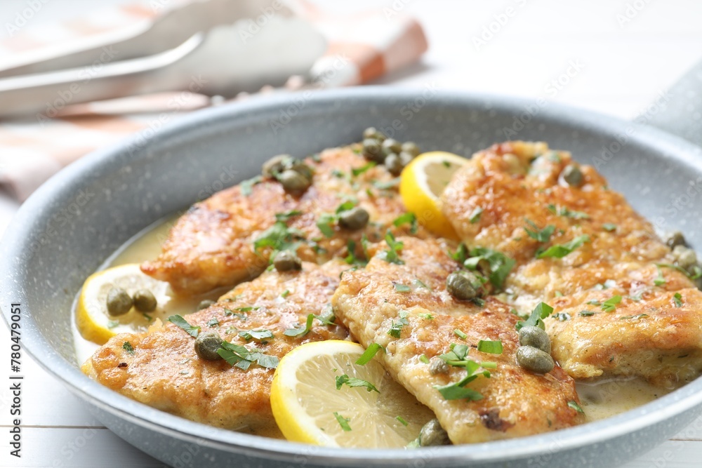 Delicious chicken piccata in pan on table, closeup Delicious chicken piccata in pan on table, closeup