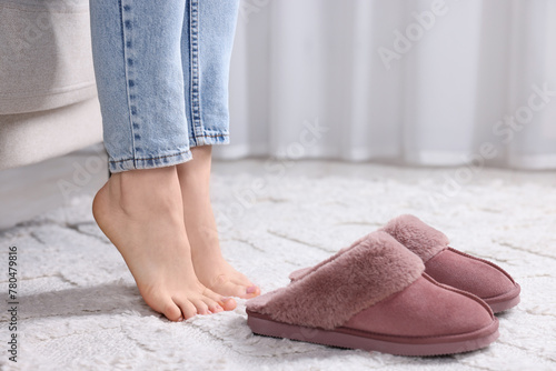 Woman near soft slippers at home, closeup