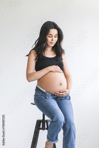 Pregnant woman sitting on a stool