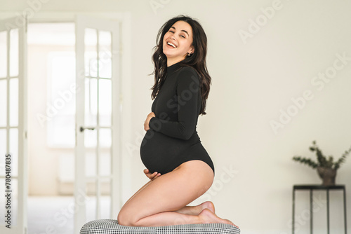 Pregnant woman sitting on stool