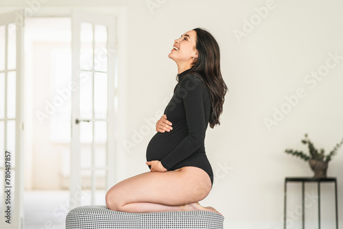 Pregnant woman sitting on stool