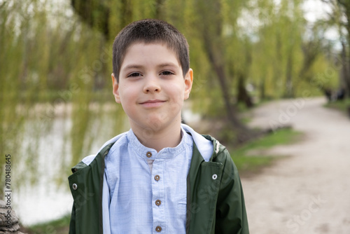 Portrait of 6 year old boy in spring park. photo